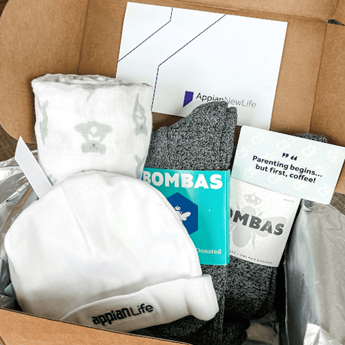 Box of goodies sent out to new parents and their child.